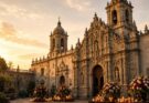 Historic baroque Catholic cathedral in Puebla, Mexico bathed in golden hour sunlight with candles and floral arrangements